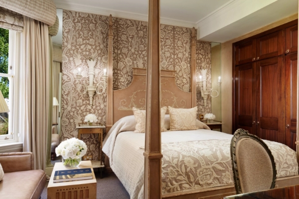 The Egerton House Hotel - a bed with a four poster bed