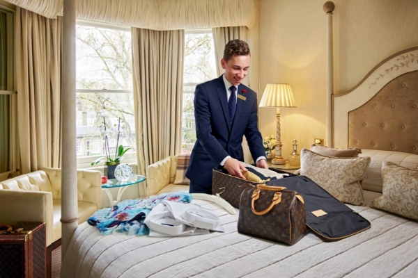 The Egerton House Hotel - a man in a suit packing a suitcase