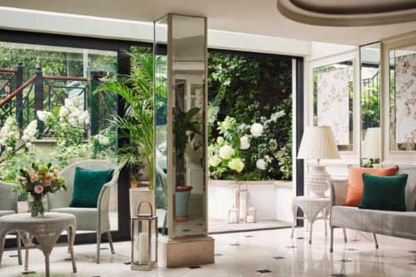 The Goring - a room with a glass wall and plants