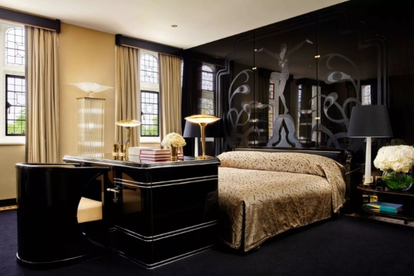 The Milestone Hotel and Residences - a bedroom with a black and gold bed