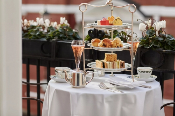 The Milestone Hotel and Residences - a tea set with a three tiered tray of food