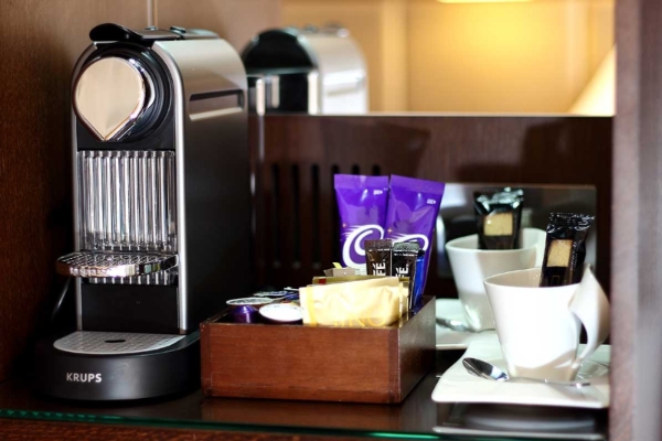 The Piccadilly London West End - a coffee machine and cups on a table