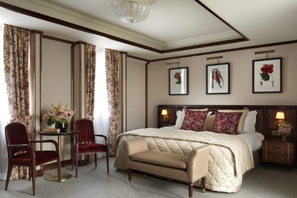 The Stafford London - a bedroom with a bed and chair