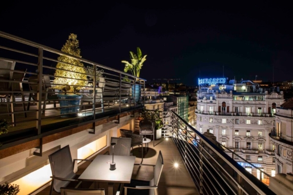 U-Visionary Roma Hotel - Rooftop terrace at night with views of Rome .