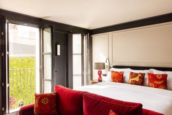 Wittmore Hotel - a bed with red pillows and a lamp in a room