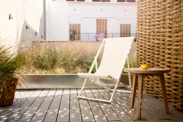 Yurbban Trafalgar Hotel - a chair on a deck